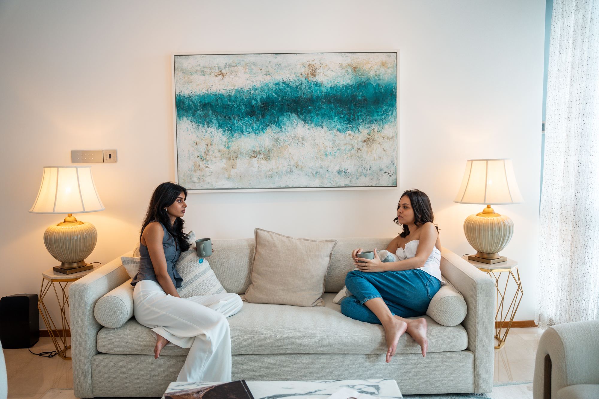 Friends catching up over coffee in a HomeConnect living room